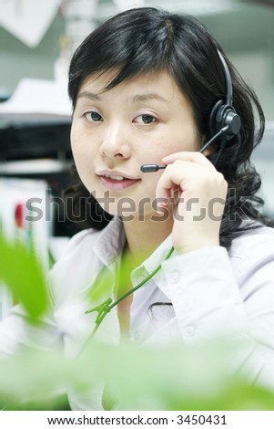 A friendly secretary/telephone operator in an office environment