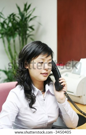 A friendly secretary/telephone operator in an office environment