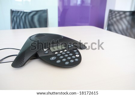 Inside a conference room - selective focus on keypad on phone