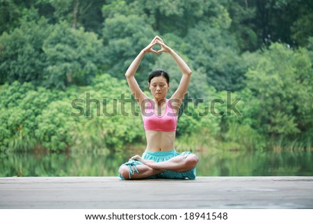 young chinese women doing yoga outside