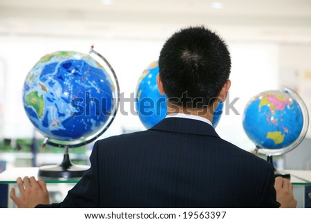 back of young businessman with earth at office building