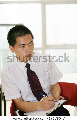 young handsome asian business man working in office