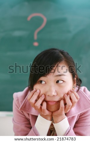 asian girl  with a red question mark on blackboard