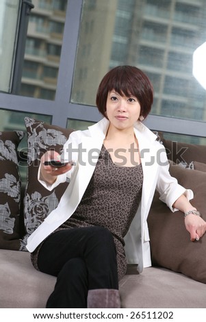 young beautiful girl sitting on chair watch TV