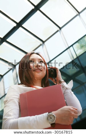 young asian business women holding folder and mobile phone
