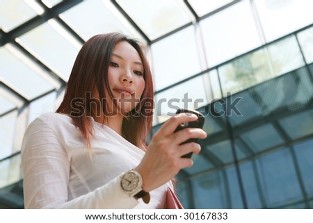 young asian business women holding folder and mobile phone
