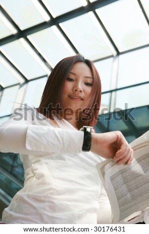 young asian business women reading newspaper