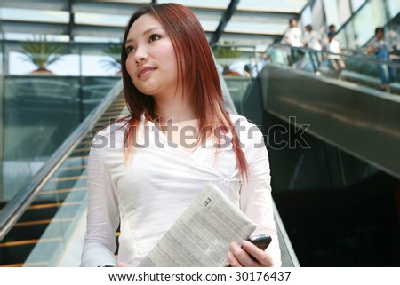 young asian business women reading newspaper
