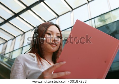 young Beautiful asian Customer Representative holding with folder