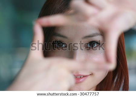 Pretty young asian woman showing thinking outside the square