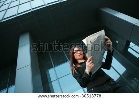 young asian business woman reading newspaper