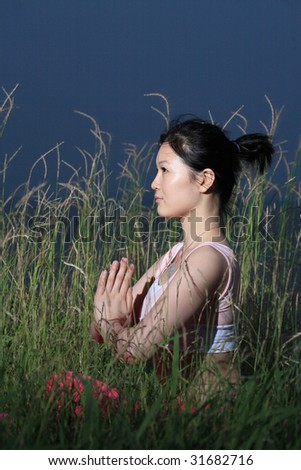 young asian woman YOGA outside at night
