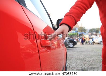 girl want open door of red car outside