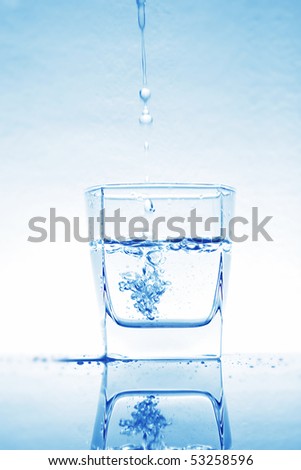 Glass of water, isolated on blue background