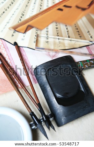 Chinese writing brushes and inkstone on the table
