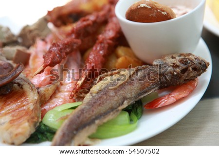 Dish of delicious fish with meat and shrimp