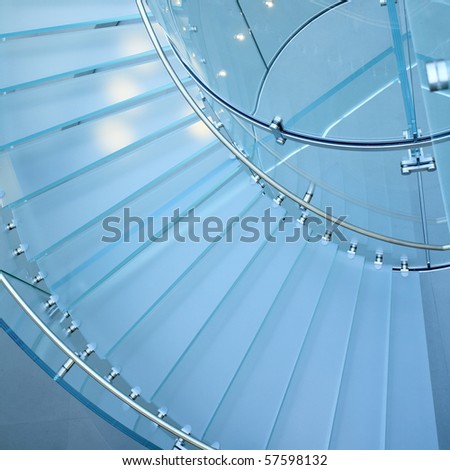 modern glass spiral staircase in shop with motion step