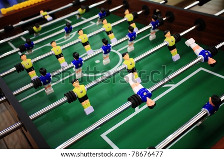 Soccer table game with yellow and blue players