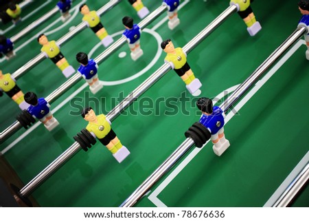 Soccer table game with yellow and blue players