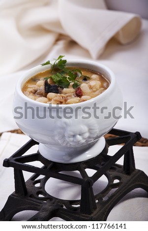 delicious dish of beans cooked with mushrooms and quail