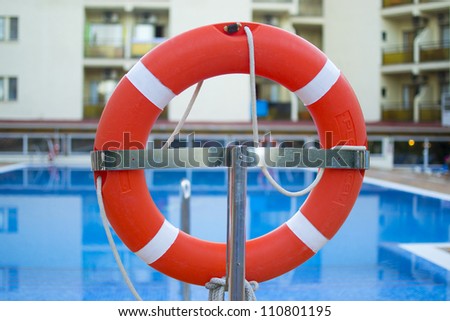 Life preserver (lifebuoy) near the pool placed on a stand