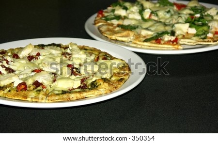 two thin crust pizzas,shallow dof