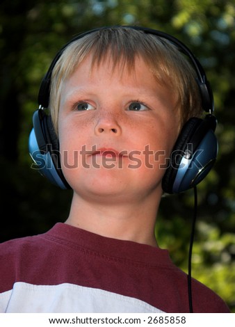 blond boy dreaming and listing to music