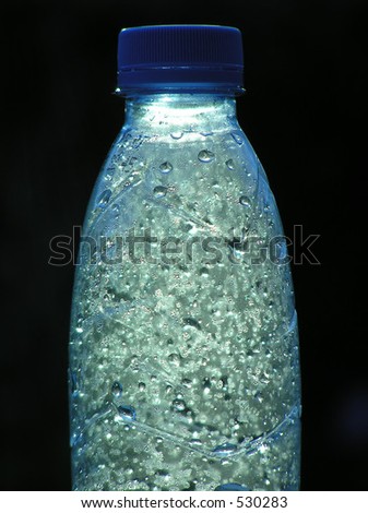 Bottle with sparkling water on black background
