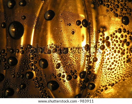 Close-up of brown water bubbles on transparent glass with lines