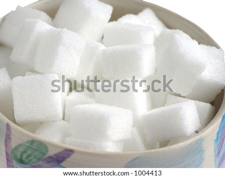 Close-up of bowl with pieces of sugar isolated on white background