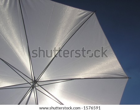 White umbrella with metal lines on a sunny day