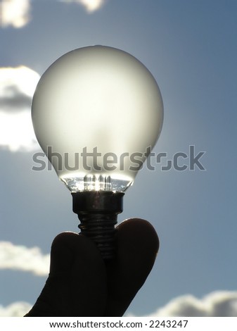 power saving light bulb against the sky