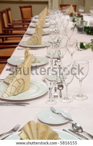 large restaurant table set up for a lot of people