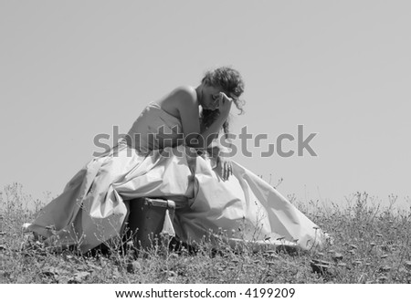 sad abandoned bride sitting on her suitcase