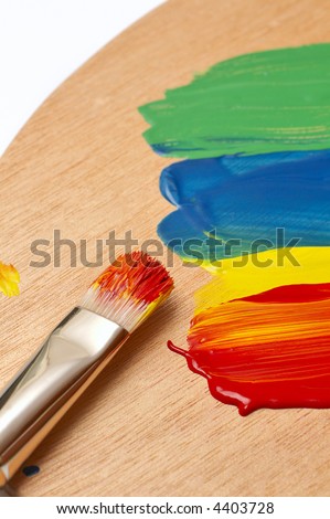 paintbrush on a color palette full of paint