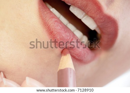 woman tracing contour of her lips