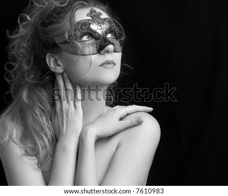 portrait of a sensual beautiful blond young woman with carnival mask, role play