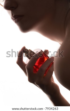 stock photo sensual woman applying perfume on her body bright red perfume