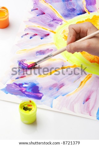 hand painting a sun, fluorescent colors