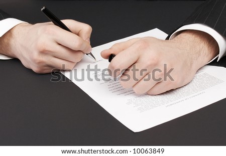 businessman signing a document; signing contract concept