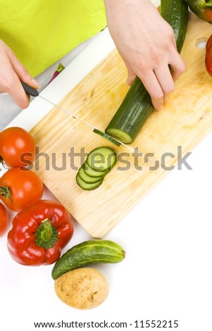 woman cutting cucumber; preparing food