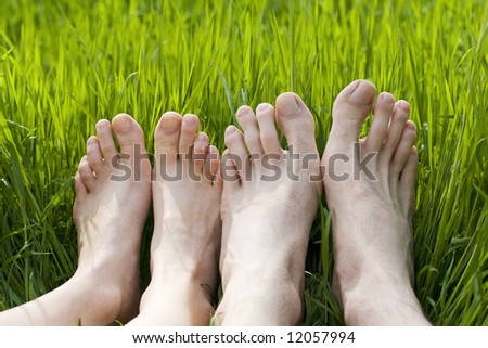 bare feet in green grass, couple relaxing in nature