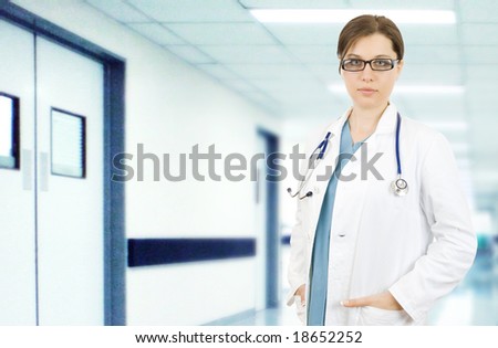 female doctor in white medical gown  in a hospital corridor