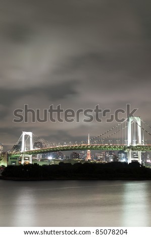 Tokyo rainbow bridge at night with Tokyo tower and skyline in the background