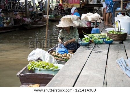 BANGKOK-NOV 17:Merchants along the canal sell vegetable and fruit at floating market on Nov 17, 2012 in Bangkok. This floating market is also known as \