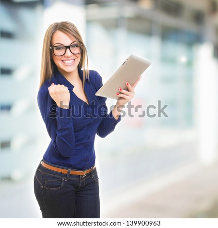 Happy young businesswoman with tablet computer