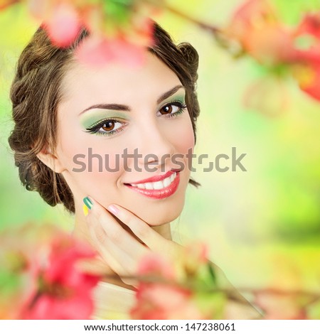 Beautiful young woman with colorful summer makeup