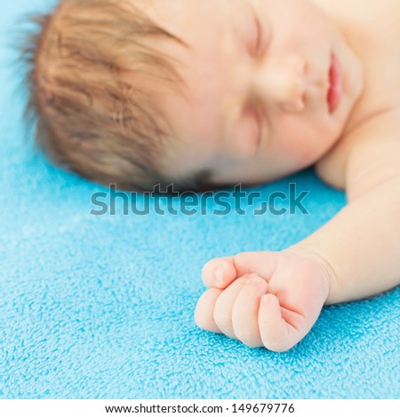 Baby boy sleeping on his favorite blue blanket
