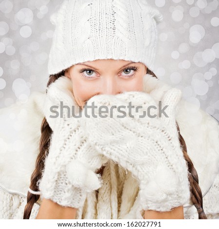 Cute young woman wearing white hat and gloves
