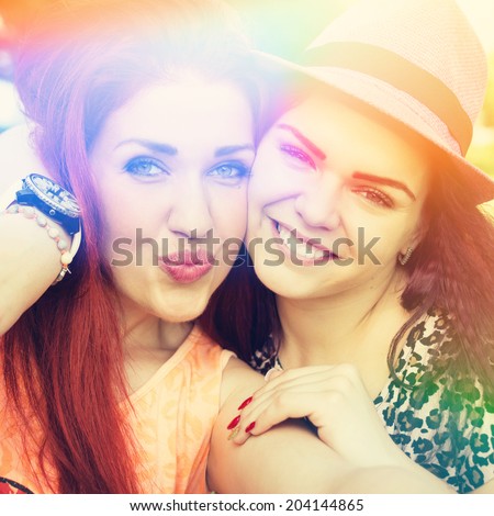Two beautiful teenage female friends taking a selfie Instagram filter Square image Closeup Color light leak Self portrait Two beautiful teenage female friends taking a selfie Instagram filter Square image Closeup Color light leak Self portrait